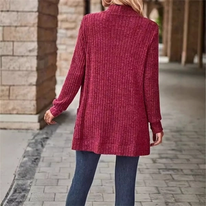 Close-up of dark red ribbed knit cardigan showing textured fabric and sleeve detail