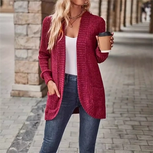 Detail of burgundy ribbed knit cardigan featuring long sleeves and functional patch pockets