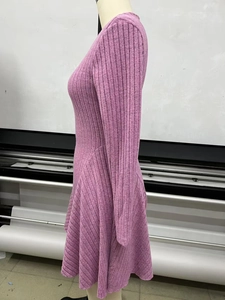 Detail view of mauve ribbed knit dress showing the vertical texture and pleated A-line hem