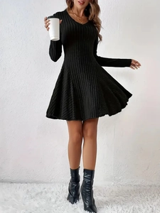 Close-up of black V-neck knitted dress with vertical ribbed texture and A-line skirt