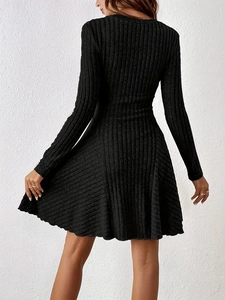 Detailed view of the vertical ribbed texture and A-line silhouette of this black knit dress