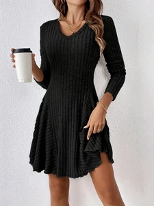 Detailed close-up of the V-neck design and rib-knit texture on the black long sleeve dress