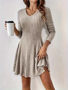 Close-up of oatmeal knit dress featuring a deep V-neck and ribbed texture for women
