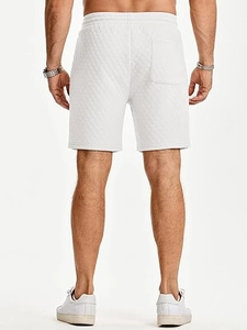 Close-up of white quilted drawstring shorts for men featuring a practical back pocket