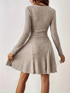 Detail of light grey ribbed knit fabric and elegant A-line silhouette of the long sleeve dress