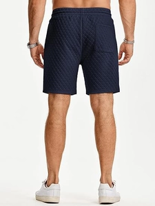 Detailed back view of navy blue quilted sports shorts with elastic waist and back pocket