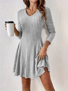 Detail view of a grey rib-knit V-neck long sleeve mini dress with a flared A-line skirt