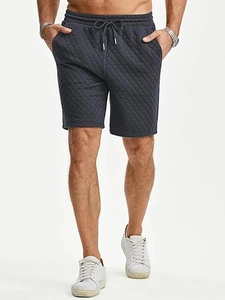 Detail view of men's dark grey quilted shorts featuring drawstring waist and side pockets