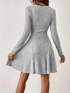 Detail of grey ribbed knit long sleeve dress showing waistline and A-line skirt drape