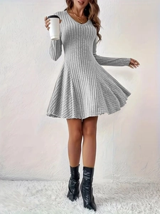 Detail of grey ribbed knit long sleeve dress showing fine texture and A-line silhouette