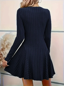 Back view of elegant dark blue long sleeve knit dress with flowing flared skirt