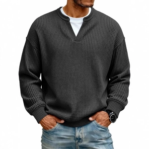 Men's dark grey waffle knit long sleeve henley shirt paired with light jeans