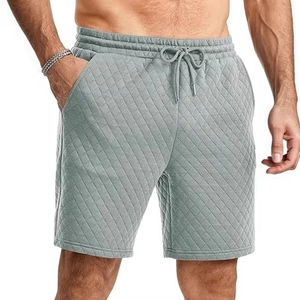 Men's grey quilted drawstring sweatpants with diamond pattern and side pockets