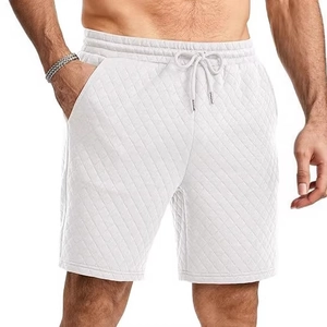Men's white quilted drawstring shorts with side pockets and textured fabric design