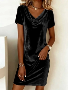 Close-up of elegant black velvet dress featuring a sophisticated cowl neck design