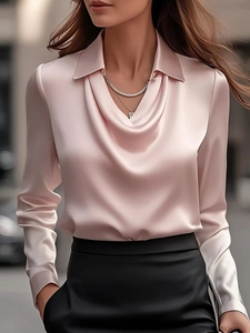 Detail of elegant pink satin blouse featuring a unique cowl neck and classic collar design