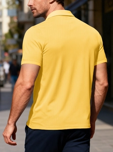 Detailed texture of breathable waffle knit fabric on yellow men's polo shirt