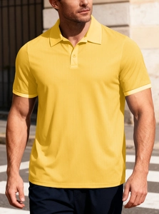 Close-up of bright yellow polo shirt with waffle texture and buttoned collar detail