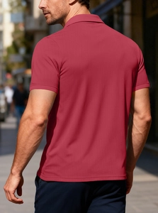 Macro shot of breathable wine red pique fabric and ribbed cuffs on men's polo shirt