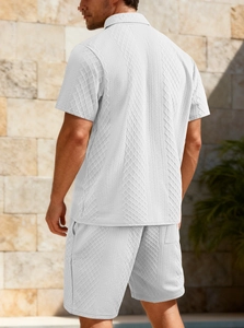 Detail shot of men's white leisure polo set featuring breathable 3D jacquard waffle texture