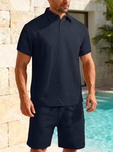 Detail of navy blue men's polo set featuring intricate geometric textured fabric