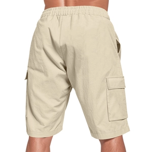 Close-up of beige cargo shorts showing elastic waistband and functional large side pockets