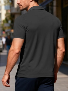 Close-up of charcoal grey short-sleeved polo shirt with waffle knit texture fabric