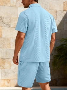 Detail of light blue men's polo set featuring 3D diamond knit texture and fabric