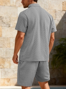 Detail of grey men's polo set featuring geometric jacquard knit texture and casual cut