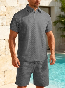 Detail of grey men's polo set featuring geometric textured knit fabric by the pool