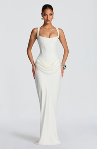 Detail of white corset maxi dress featuring draped detailing and a slim-fit silhouette