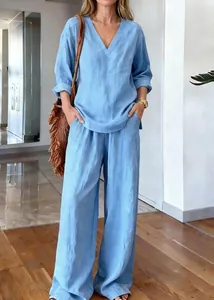Detail of light blue cotton linen set featuring V-neck long sleeve top and wide-leg pants
