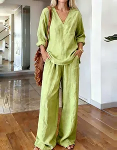 Detail of light green V-neck long sleeve top and wide leg pants in linen blend fabric