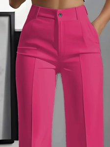 Detail of high-waisted magenta dress pants with button closure and pressed front creases
