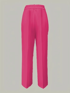 Detail of high waist pleated fuchsia straight trousers with elastic waistband