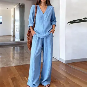 Women's chic light blue two-piece set with V-neck top and matching wide leg trousers