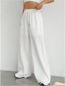 Detail of high waist white trousers with adjustable drawstring and large functional pockets