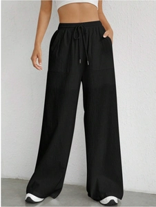 Detailed macro view of the elastic waistband with adjustable drawstring and fabric texture