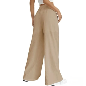Detail of khaki wide-leg trousers featuring elastic high waist and vertical textured fabric