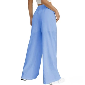 Detail view of light blue wide-leg casual pants showing back drape and elastic high waist
