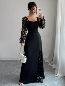 Elegant black maxi dress featuring 3D floral lace sleeves and a high slit detail