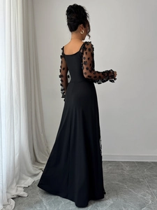 Macro view of elegant lace dress sleeves with delicate 3D floral appliques and sheer mesh