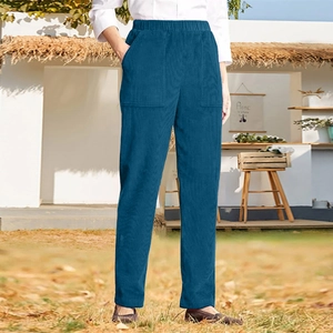 Close-up of blue corduroy straight trousers showing elastic waist and large patch pockets