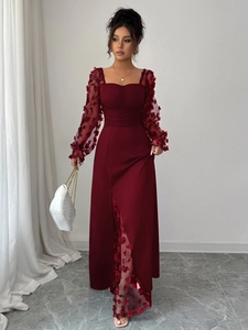 Detailed close-up of dark red lace dress featuring sheer sleeves and 3D floral petals