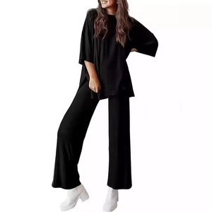 Women's two-piece black lounge set with round neck top and wide leg pants