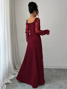 Detailed back view of deep red lace maxi dress featuring sheer sleeves with 3D petals