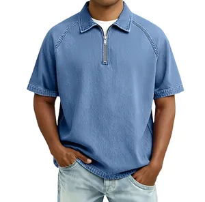 Detail of light blue denim polo shirt featuring a half-zip neckline and raglan sleeves