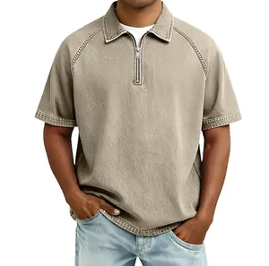 Detail of men's vintage washed polo shirt with raglan sleeves and half-zipper collar