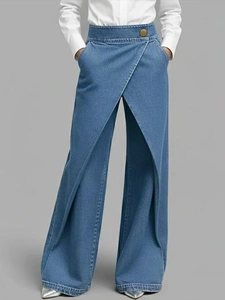Detail view of high waist wide leg pants with overlap waist and golden metal button