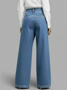 Detail view of high waist wide leg denim trousers with vintage washed texture